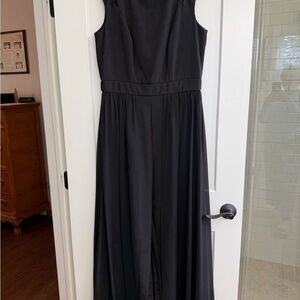 Black  jumpsuit with overlay from the sidewaist down open in the front